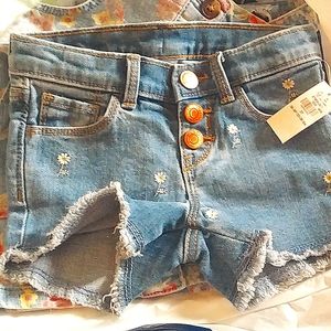 Denim shorts with small daisies on them
